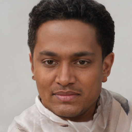 Joyful black young-adult male with short  black hair and brown eyes