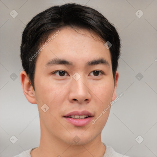 Joyful asian young-adult male with short  brown hair and brown eyes