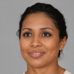 Joyful black young-adult female with medium  brown hair and brown eyes