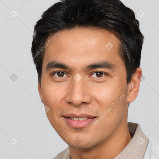 Joyful white young-adult male with short  black hair and brown eyes