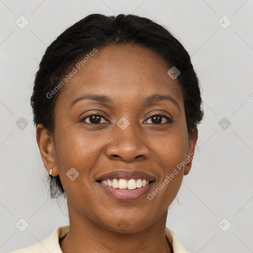 Joyful black adult female with short  brown hair and brown eyes