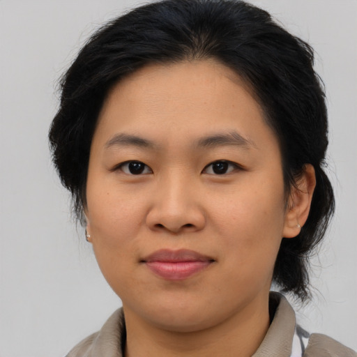 Joyful asian young-adult female with medium  brown hair and brown eyes