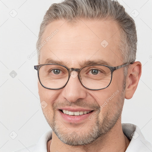 Joyful white adult male with short  brown hair and brown eyes