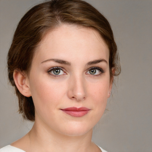 Joyful white young-adult female with medium  brown hair and blue eyes