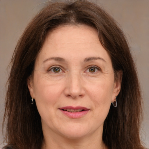 Joyful white adult female with medium  brown hair and brown eyes