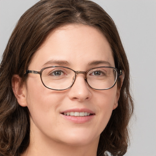 Joyful white young-adult female with medium  brown hair and green eyes