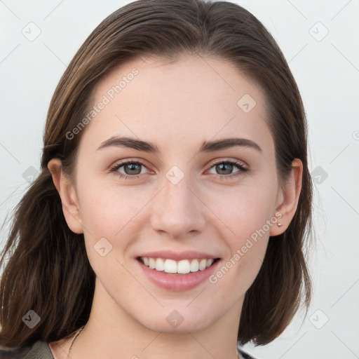 Joyful white young-adult female with long  brown hair and blue eyes