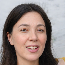 Joyful white adult female with long  brown hair and brown eyes