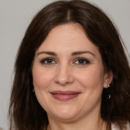 Joyful white adult female with medium  brown hair and brown eyes