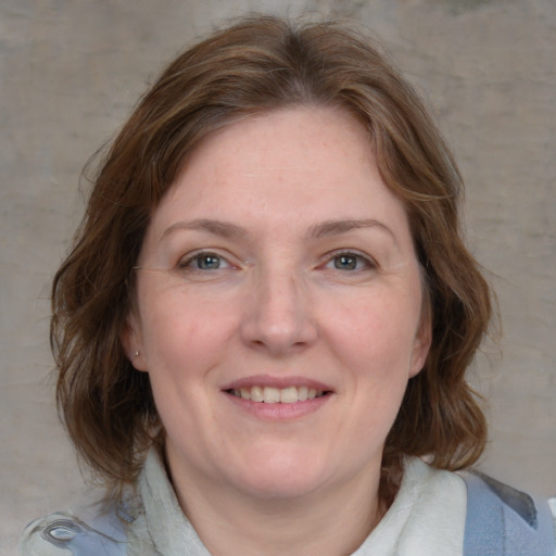 Joyful white young-adult female with medium  brown hair and blue eyes