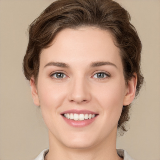 Joyful white young-adult female with medium  brown hair and green eyes