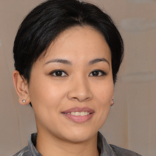Joyful asian young-adult female with medium  brown hair and brown eyes
