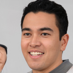 Joyful asian young-adult male with short  black hair and brown eyes