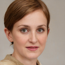 Joyful white young-adult female with medium  brown hair and blue eyes