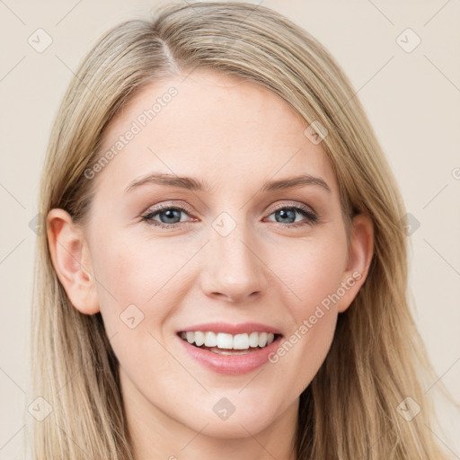 Joyful white young-adult female with long  brown hair and blue eyes