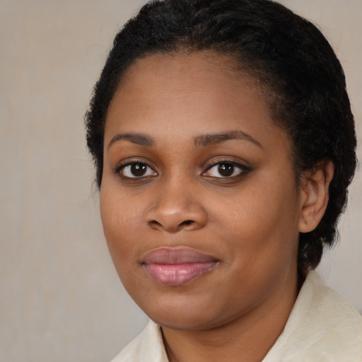 Joyful black young-adult female with medium  brown hair and brown eyes