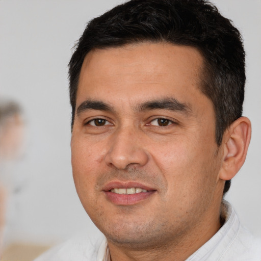 Joyful white young-adult male with short  black hair and brown eyes