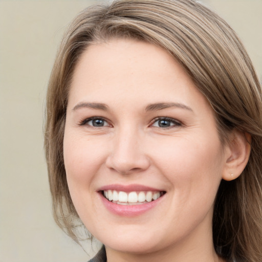 Joyful white young-adult female with long  brown hair and brown eyes