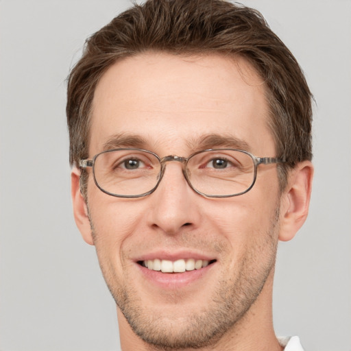 Joyful white adult male with short  brown hair and grey eyes