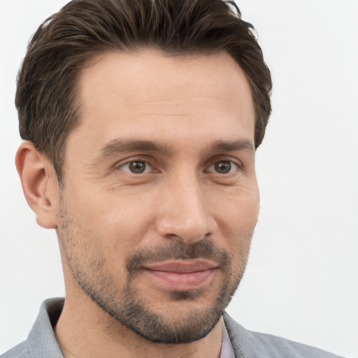 Joyful white adult male with short  brown hair and brown eyes