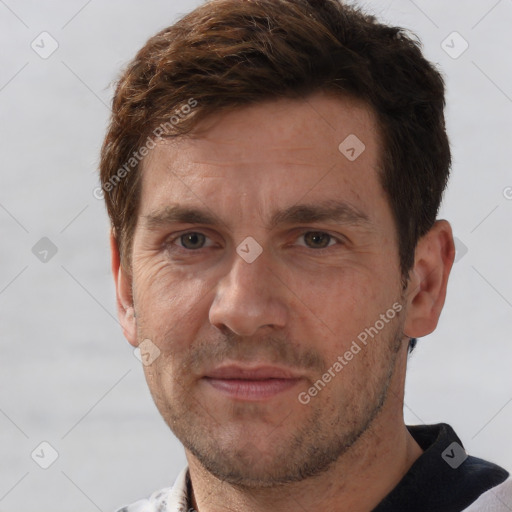 Joyful white adult male with short  brown hair and grey eyes