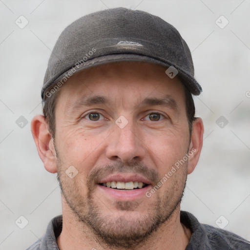 Joyful white adult male with short  brown hair and grey eyes