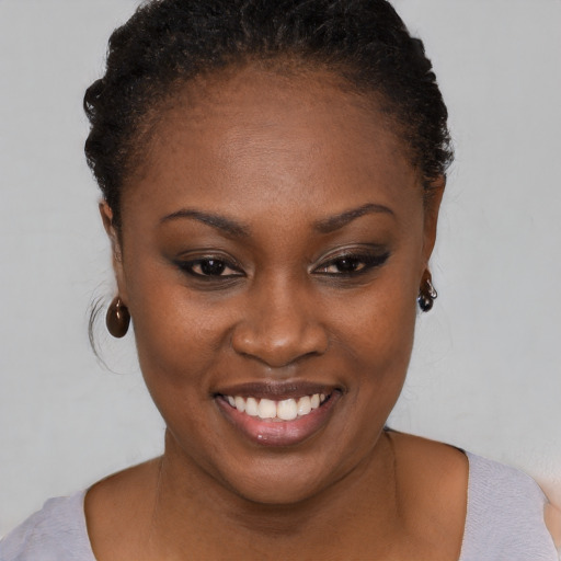 Joyful black young-adult female with short  brown hair and brown eyes