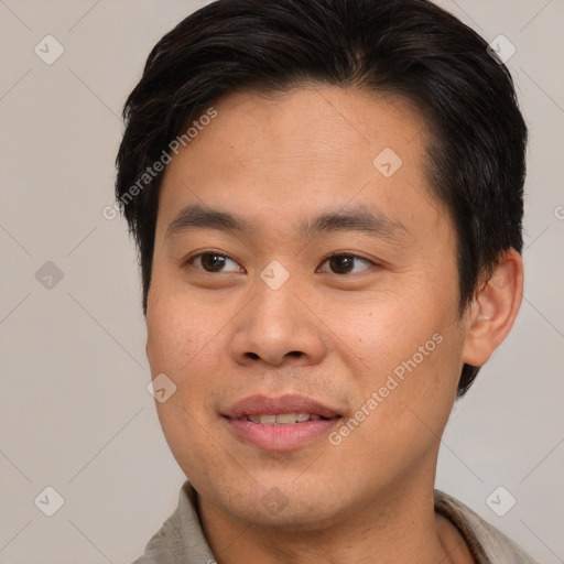 Joyful asian young-adult male with short  brown hair and brown eyes