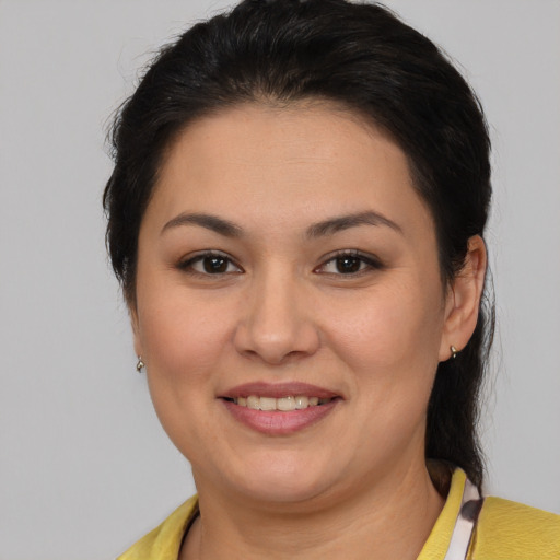 Joyful latino young-adult female with medium  brown hair and brown eyes