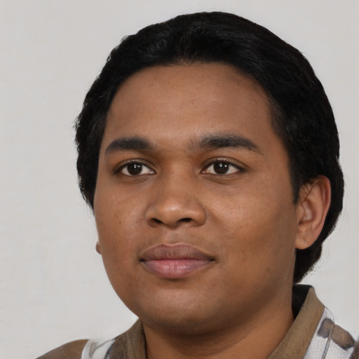 Joyful black young-adult male with short  black hair and brown eyes