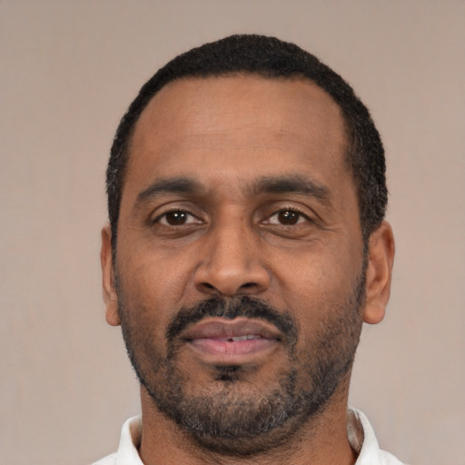 Neutral latino adult male with short  black hair and brown eyes