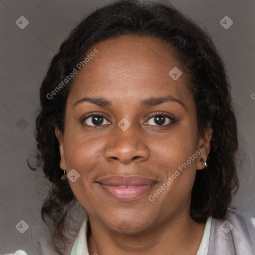 Joyful black adult female with long  brown hair and brown eyes