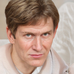 Joyful white adult male with short  brown hair and grey eyes