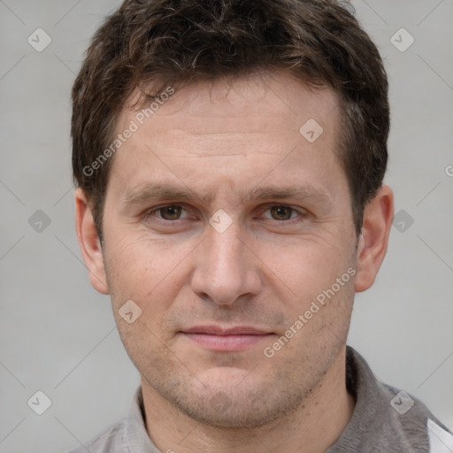 Joyful white adult male with short  brown hair and grey eyes