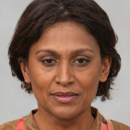 Joyful white adult female with medium  brown hair and brown eyes