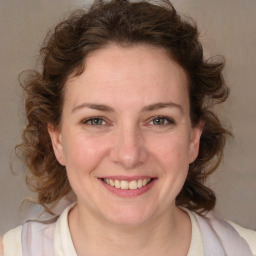 Joyful white young-adult female with medium  brown hair and blue eyes