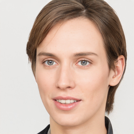 Joyful white young-adult female with medium  brown hair and grey eyes