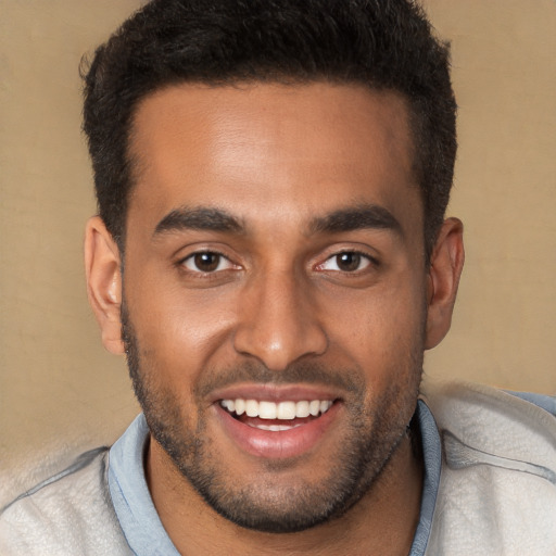 Joyful black young-adult male with short  brown hair and brown eyes