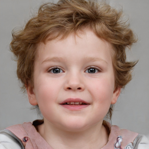 Joyful white child male with short  brown hair and blue eyes