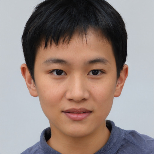 Joyful asian child male with short  brown hair and brown eyes