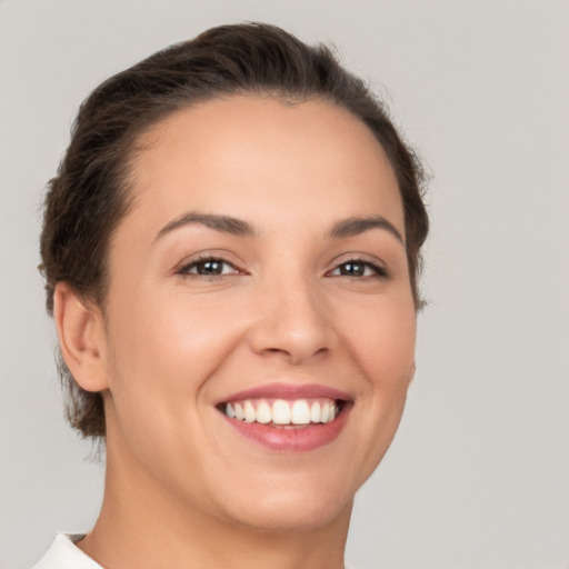 Joyful white young-adult female with short  brown hair and brown eyes