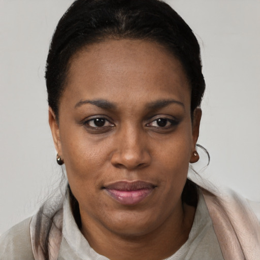 Joyful black young-adult female with short  black hair and brown eyes