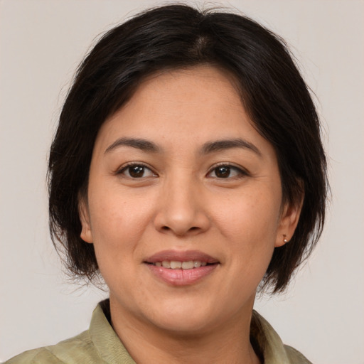 Joyful white adult female with medium  brown hair and brown eyes