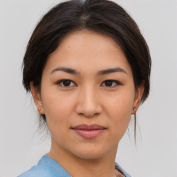 Joyful asian young-adult female with medium  brown hair and brown eyes