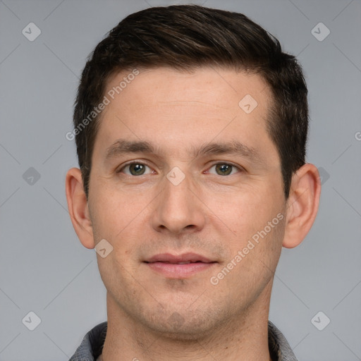 Joyful white young-adult male with short  brown hair and grey eyes