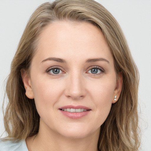 Joyful white young-adult female with medium  brown hair and blue eyes