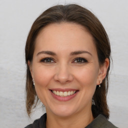 Joyful white young-adult female with medium  brown hair and brown eyes