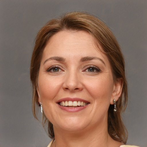 Joyful white adult female with medium  brown hair and brown eyes