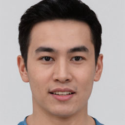 Joyful asian young-adult male with short  black hair and brown eyes