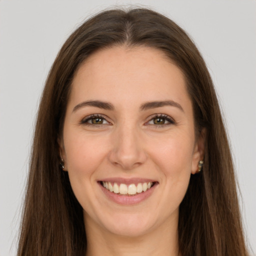 Joyful white young-adult female with long  brown hair and brown eyes